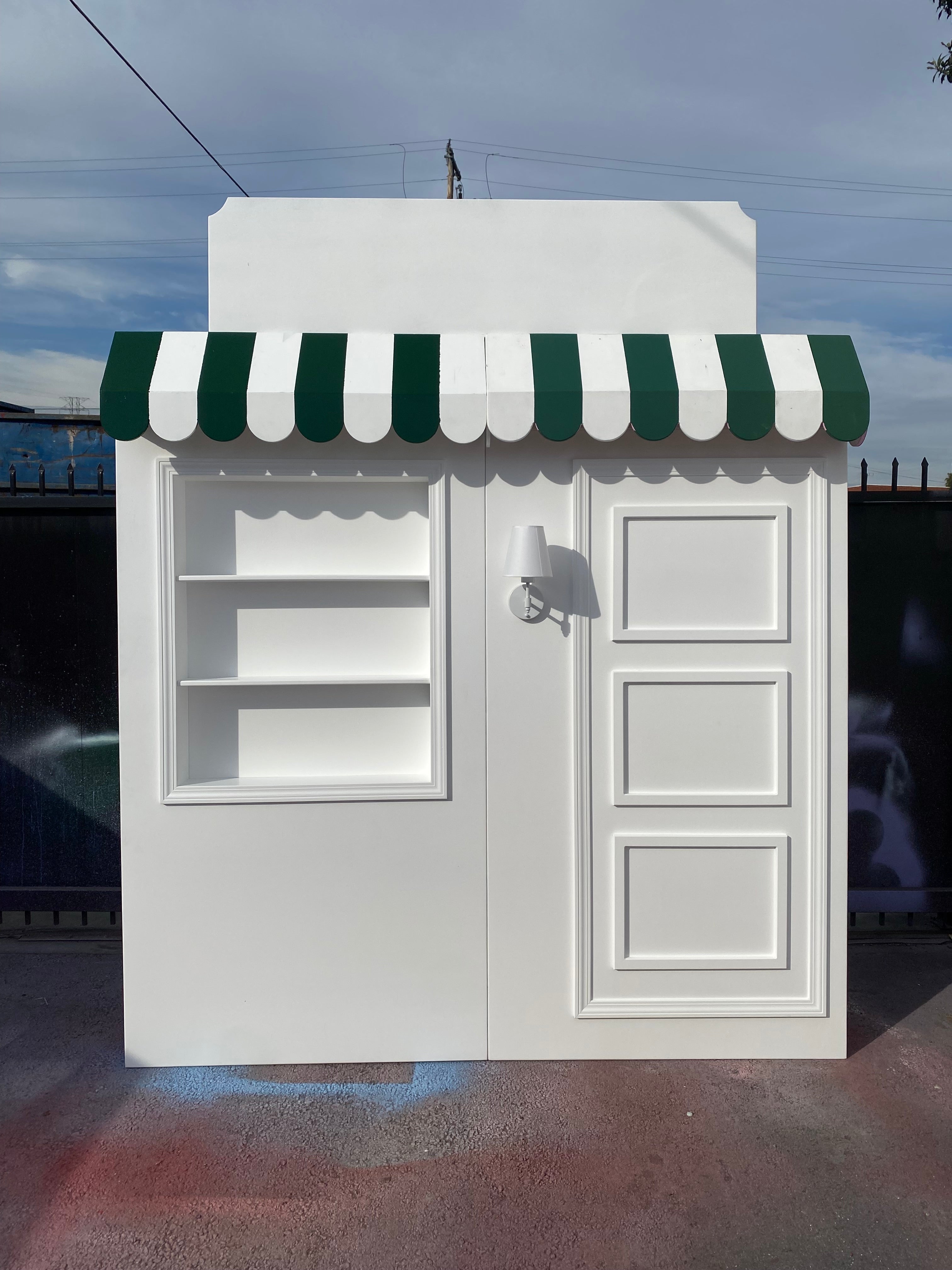 White Store Front With Custom Signage & Interchangeable Color Awning